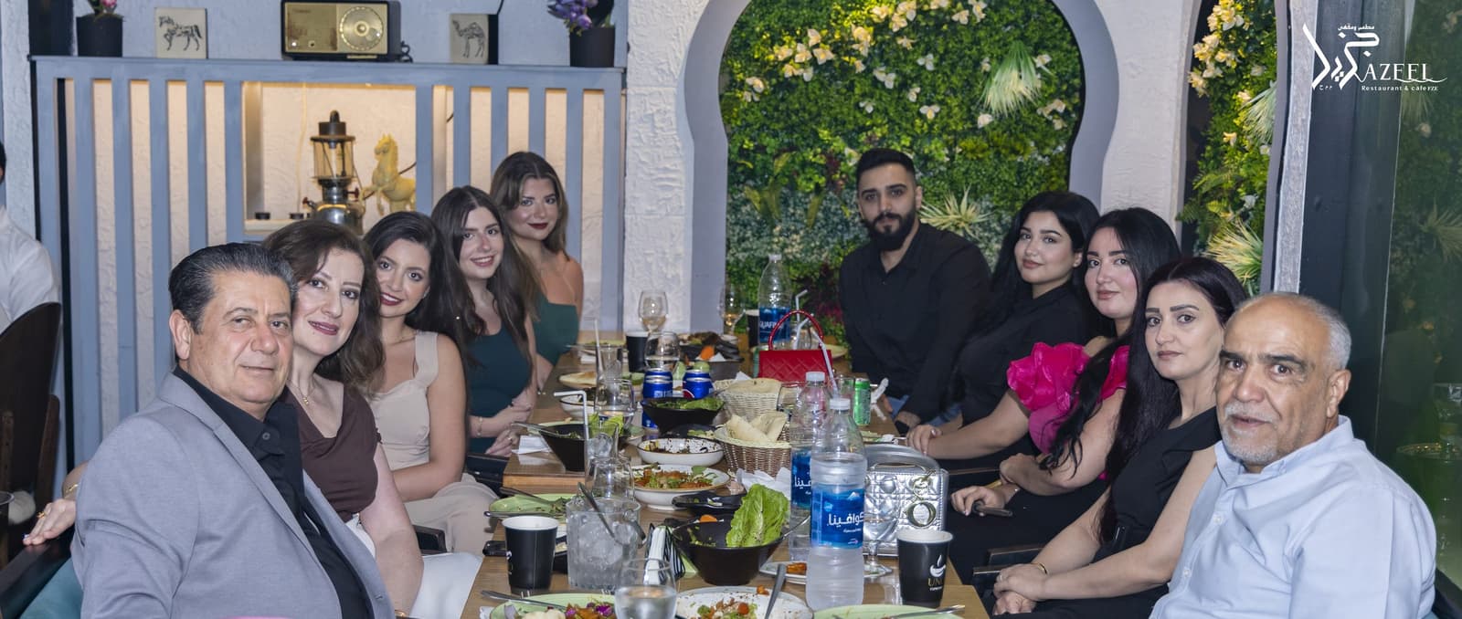 A family group seated along a long table set for a celebration