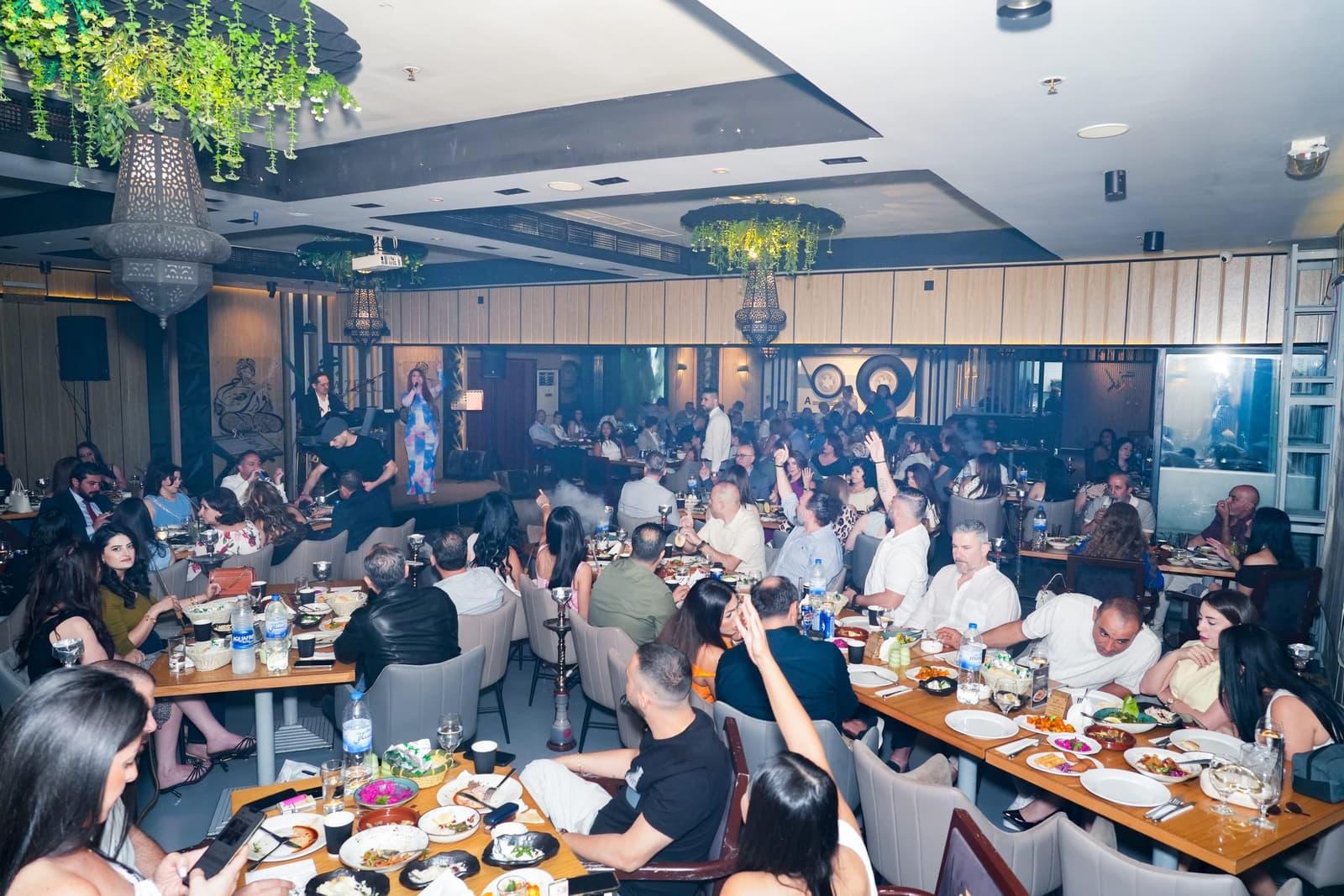 The dining room during a live performance, guests seated throughout