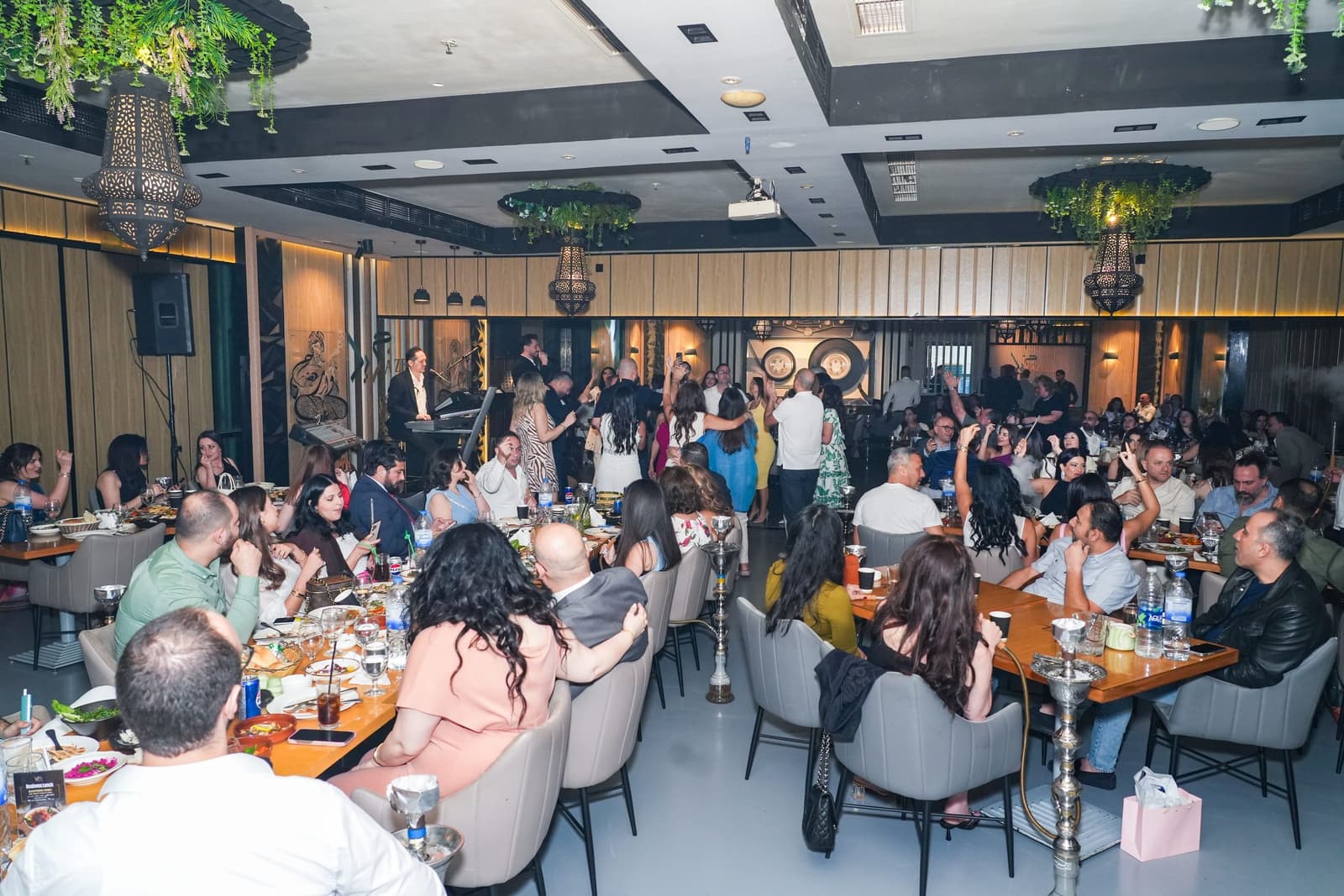 A wide view of the indoor dining room during an evening