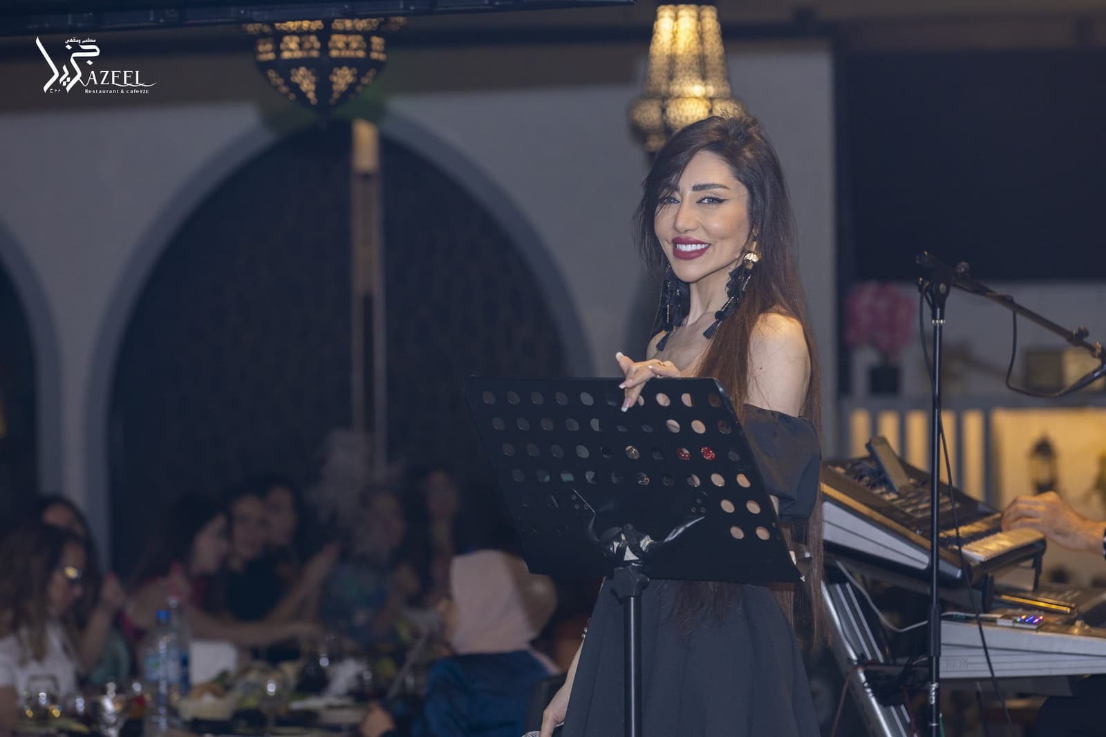 A singer performing beside the keyboard player during an evening at Jazeel